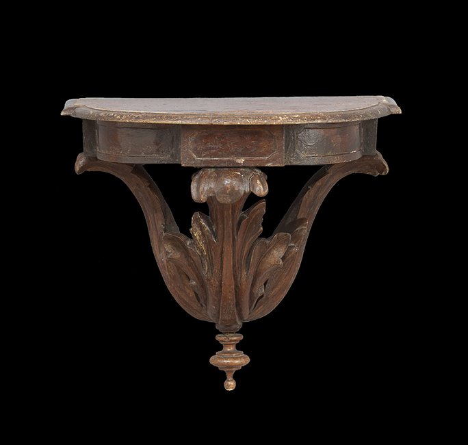 Latin American Spanish Cedar Wall Bracket: Latin American Spanish Cedar Wall Bracket, fourth quarter 19th century, in the neoclassical taste, having openwork acanthus leaves supporting a skirt with inset panels, h. 15-1/2".