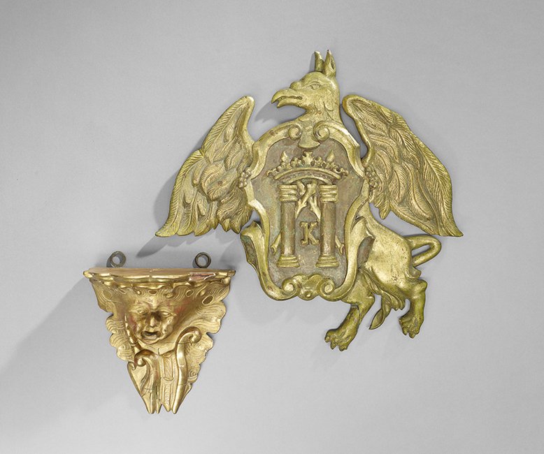 Two-Piece Group of Continental Giltwood Items: Two-Piece Group of Continental Giltwood Items, consisting of an unusual mask molded bracket, fourth quarter 19th century, h. 9", w. 8", d. 4-1/2", and a heraldic plaque, h. 13", w. 17-1/4".