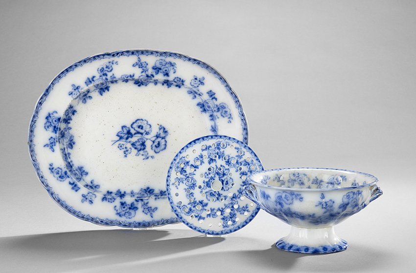 Three-Pieces of Staffordshire Flow Blue Porcelain: Three-Piece Group of Staffordshire Flow Blue Porcelain, third quarter 19th century, including a platter, l. 17", w. 14", a compote, h. 5", dia. 9-1/2", and a strainer insert, dia. 7-1/2".