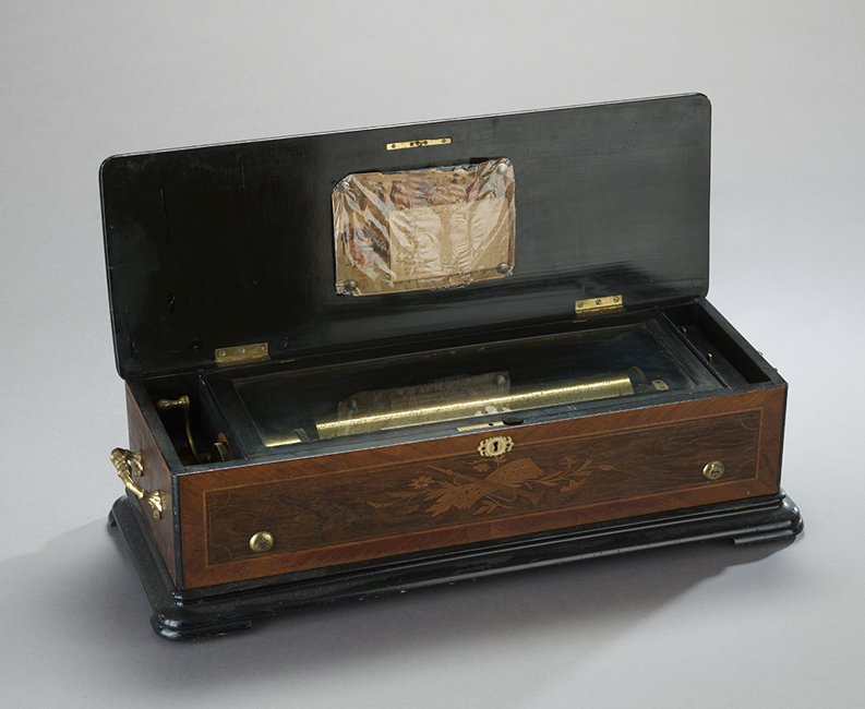Swiss Single-Cylinder Music Box: Swiss Single-Cylinder Music Box, fourth quarter 19th century, in a marquetry-inlaid case with a carved ivory escutcheon, playing twelve airs, h. 7-3/4", w. 27-1/2", d. 10-1/4".