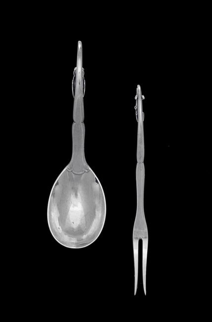 Two Georg Jensen Sterling Salad Serving Pieces: Two Georg Jensen Ornamental Pattern Number 21 Sterling Silver Salad Serving Pieces, the pattern designed ca. 1906 by Georg Jensen (1866-1935), Copenhagen, including a lemon fork with the Jensen mark i