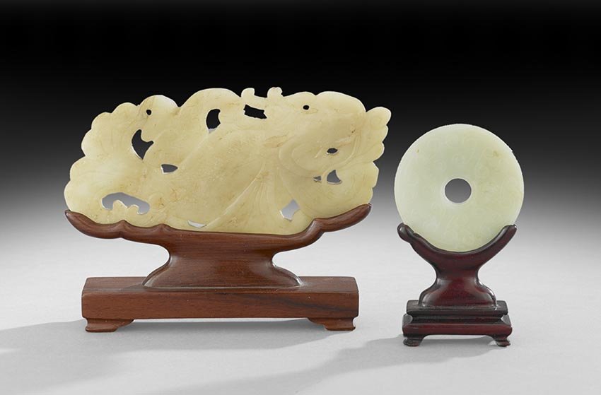 Two Chinese Jade Carvings: Two Chinese Jade Carvings, 19th century or earlier, including a celadon brown-colored dragon carp, l. 5-1/2", and a Pi disk carved with a grain pattern of commas, dia. 2-1/4", both presented on confor