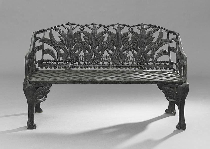 Victorian-Style Cast Iron Garden Bench: Victorian-Style Cast Iron Garden Bench, the back molded as a row of lilies, with a grid-pattern seat, after a pattern made by Coalbrookdale in the 19th century, h. 35-1/2", w. 57", d. 19-1/4".