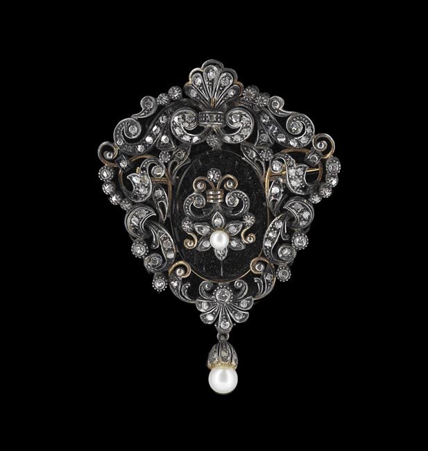 18 Kt. Gold, Diamond & Onyx Brooch: Eighteen-Karat Yellow Gold, Silver, Diamond, Pearl and Black Onyx Brooch, the rococo-style brooch with a gold back and silver top set with approximately 100 rose-cut diamond melee and three single-cut
