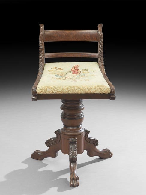 American Late Classical Mahogany Piano Stool: American Late Classical Mahogany Piano Stool, late 19th century, the rotating and extending seat with a low back extending to foliate- and dolphin-carved rails, on a tripodal ring-turned base, the leg