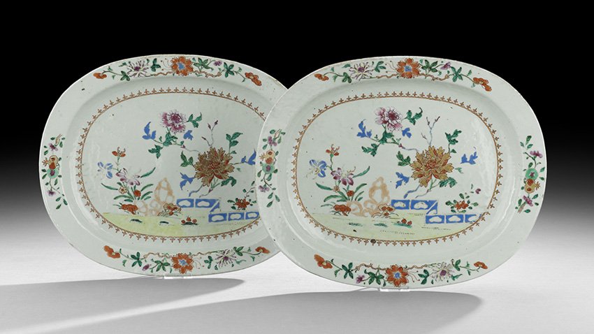 Pair of Chinese Export Porcelain Serving Dishes: Pair of Chinese Export Porcelain Serving Dishes, probably mid-18th century, the oval dishes with reserves depicting an arrangement of flowers and scholar's rocks, in the famille rose palette with a gi