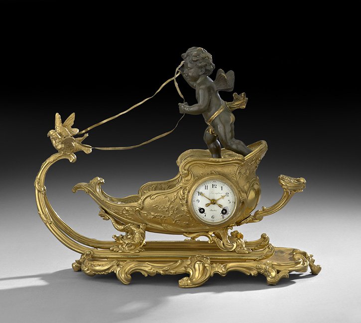 French Gilt-Bronze Figural Mantel Clock: French Gilt-Bronze Figural Mantel Clock, first quarter 20th century, in the Louis XV style, retailed by Shreve, Crump and Low, Boston, and marked on the enamel dial, the clock depicting a patinated br