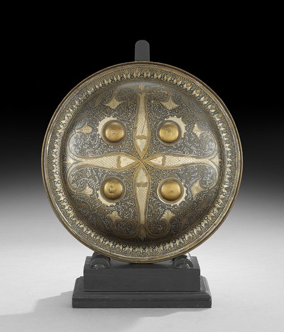 Middle Eastern Steel and Brass Shield: Middle Eastern Steel and Brass Shield, ca. 1900, with Persian-style damascene decoration of fish on a ground of intertwined vines, with applied bosses and brass, dia. 15-1/4".