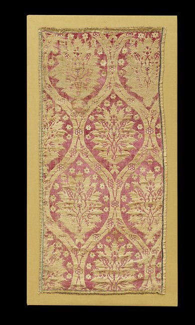 Unusual Middle Eastern Framed Textile: Unusual Middle Eastern Framed Textile, with Moorish arched panels depicting leaves and flowers on a faded scarlet ground, h. 48-1/2", w. 24-3/4".