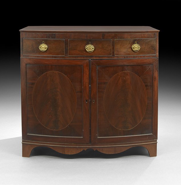 American Federal Mahogany Bowfront Server/Press: American Federal Mahogany Bowfront Server/Press in the Hepplewhite Taste, ca. 1800, Baltimore or Philadelphia, the case with a band of three beaded drawers over a pair of doors, each with figured ovoi