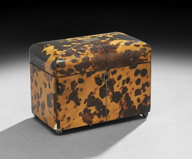 English Regency-Style Tortoiseshell Tea Caddy: English Regency-Style Tortoiseshell Tea Caddy, fourth quarter 19th century, with a silverplated escutcheon and cover cartouche, raised on ball feet, h. 4-3/4", w. 6-1/2", d. 3-3/4".