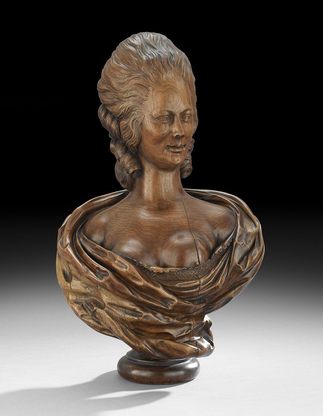 Carved Walnut Bust of Marie Antoinette: Carved Walnut Bust of Marie Antoinette, 19th century, probably French, carved from a single piece of walnut, except for the socle, depicted wrapped in a cloak, with carefully carved lace accentuating 