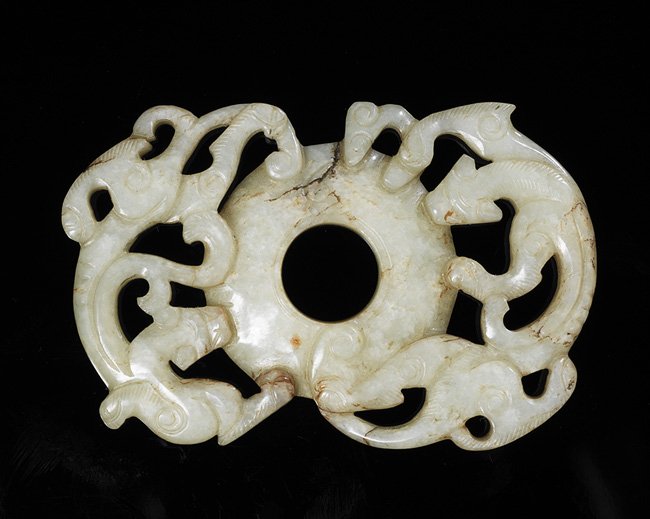 Chinese Carved Jade Bi Disk: Chinese Carved Jade Bi Disk, Ming Dynasty (1368-1644), possibly 15th century, the white jade bi disk flanked by a pair of Chilong dragons, the reverse with a "rice grain" pattern carved on the surface