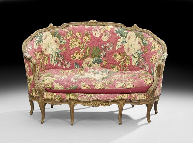 Louis XV Fruitwood Canape: Louis XV Fruitwood Canape, late 18th century, the padded back and downswept arms within a molded and foliate-carved frame, the cushioned seat raised above a scalloped floral-carved apron on molded cab
