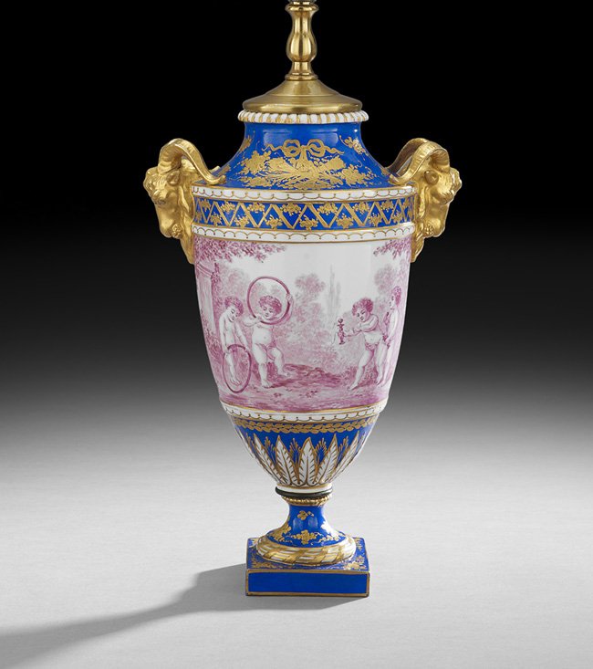 Sevres-Style Gilded Porcelain Garniture Urn: Sevres-Style Hand-Painted and Gilded Porcelain Garniture Urn, fourth quarter 19th century, now mounted as a lamp, with raised gilt decoration on a bleu du roi ground, framing the central panel depicti