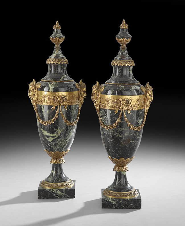 Pair of French Marble and Bronze Garniture Urns: Pair of French Verde Antique Marble and Bronze Garniture Urns, mid-20th century, the ovoid urns decorated with swags of flowers on bas-relief-molded borders, terminating in masque handles, the integra