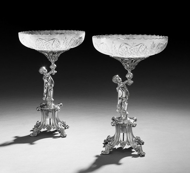 Pair of Silverplate and Cut Glass Fruit Stands: Pair of American Silverplate and Cut Glass Fruit Stands, second quarter 20th century, by the Goldfelder Silver Co., Yalesville, Connecticut, in the Victorian taste, each with a figural standard of a p