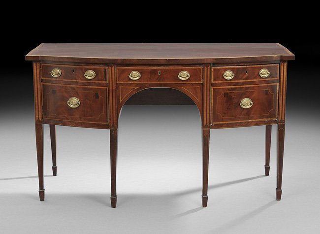 George III Mahogany Bowfront Sideboard: George III Mahogany Bowfront Sideboard, early 19th century, the banded and bowed top above a conforming case fitted with a central drawer flanked to one side by a cupboard door and to the other by a s