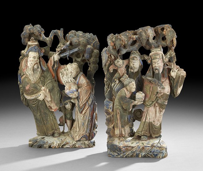Two Chinese Polychrome Wood Carvings: Two Chinese Polychrome Wood Carvings, probably 19th century or earlier, the two carved architectural elements depicting groups of immortals and their youthful attendants, both pieces finished in a pal