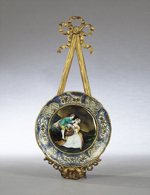 French Champleve Enamel Wall Plaque: French Champleve Enamel Wall Plaque, second quarter 20th century, the circular plaque depicting a courting couple within a lattice and floral band, fixed to a gilt-bronze "ribbon" mount, marked "Made