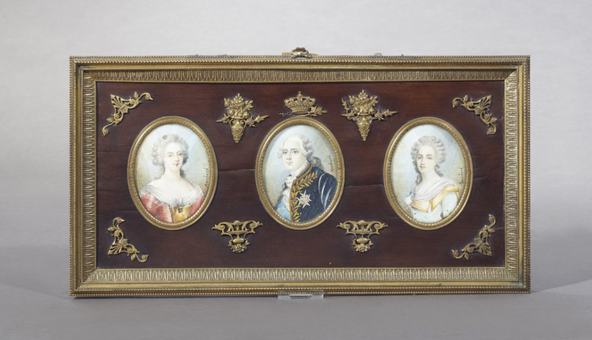 Three French Portrait Miniatures on Ivory: Three French Belle Epoque Portrait Miniatures on Ivory, first quarter 20th century, in a bronze and mahogany frame, depicting Louis XVI, flanked by Madame du Barry and Marie Antoinette, h. 8-1/4", w. 