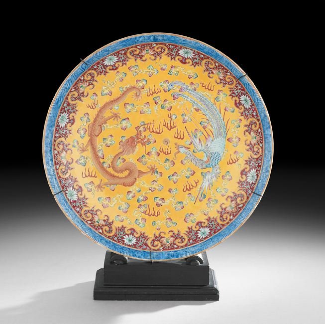 Chinese Porcelain Charger: Chinese Porcelain Charger, 19th/20th century, with a dragon and phoenix positioned around a sacred pearl against a yellow ground, with red floral and blue meander borders, the underside with a six-cha