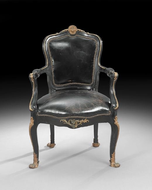 Louis XV-Style Ormolu-Mounted Fauteuil: Louis XV-Style Ebonized and Ormolu-Mounted Fauteuil, early 20th century, the curved and shaped padded back surmounted by an ormolu shell crest, joined to the padded seat by like arms, raised on cabrio