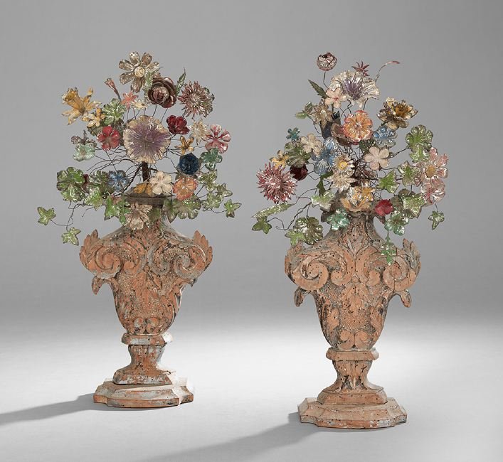 Pair of Italian Baroque Wood and Tole Garnitures: Pair of Italian Baroque Wood and Tole Garnitures, mid-18th century and later, the leaf-carved urn-form bases retaining traces of silver gilt, and set with sprays of painted tole and wirework flowers,