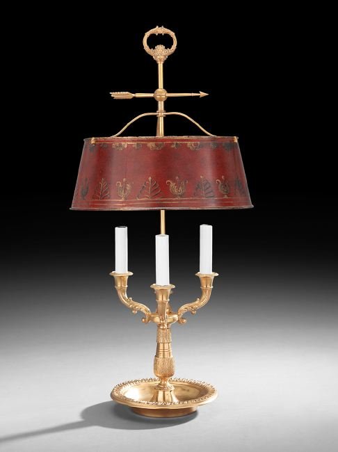 French Gilt-Bronze and Tole Bouillotte Lamp: French Gilt-Bronze and Tole Bouillotte Lamp in the Restauration Style, second quarter 20th century, the leaf-molded three-light bronze base set with a red tole shade decorated with gilt anthemia, h. 2