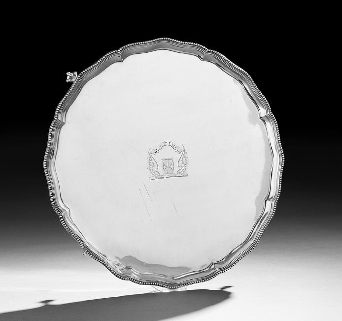 George III Sterling Silver Salver: George III Sterling Silver Salver, hallmarked London, 1786-1787, by Elizabeth Jones, of circular form, with beaded, serpentine-lobed rim, raised on four ball-and-claw feet, engraved with the crest and