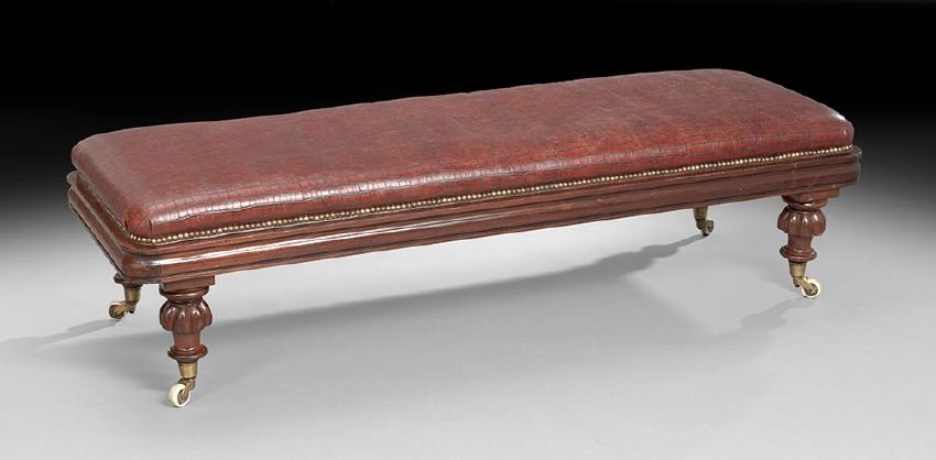 William IV Mahogany Bench: William IV Mahogany Bench, second quarter 19th century, the long padded rectangular top above an ogee-molded frieze, raised on large ribbed toupie feet ending in casters, h. 18", w. 67", d. 23-1/2".