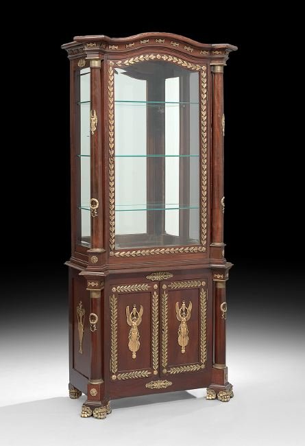 Empire-Style Mahogany Display Cabinet: Empire-Style Mahogany Display Cabinet, late 19th century, the slightly domed and molded cornice with projecting corners, over a conforming case fitted with a beveled glazed door, flanked to either sid