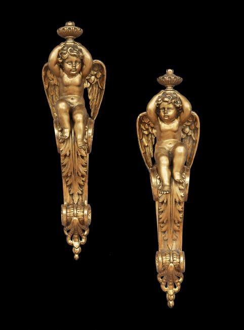Pair of Italian Carved Giltwood Corbels: Pair of Italian Carved Giltwood Corbels, 20th century, in the neoclassical taste, the leaf-carved brackets decorated with deeply modeled fleurettes, and holding seated cherubs supporting urns on their