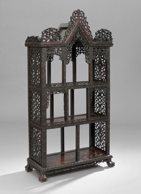 Anglo-Colonial Rosewood Etagere: Anglo-Colonial Rosewood Etagere, late 19th century, the gabled cornice above three shelves, all with foliate-carved dividers and elaborately carved and scrolling side panels, raised on ball-and-claw f