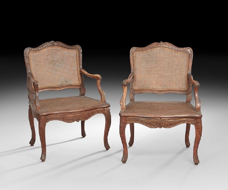 Pair of Louis XV-Style Fruitwood Fauteuils: Pair of Louis XV-Style Fruitwood Fauteuils, 19th century, each with a caned back surmounted by a shell crest, joined by scrolling arms to the cushioned caned seat, raised on cabriole legs ending in fo