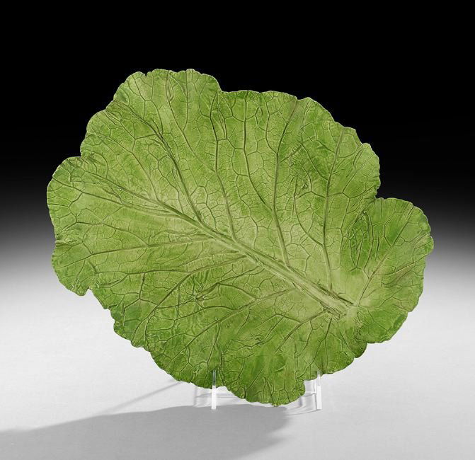 Mary Kirk Kelly (American/Alabama, 1918-2013): Mary Kirk Kelly (American/Alabama, 1918-2013), earthenware collard leaf tray, one of ten created, unsigned but inscribed "Collard Leaf/Model from Mom's garden/June 1986, l. 14", w. 10-3/4".
