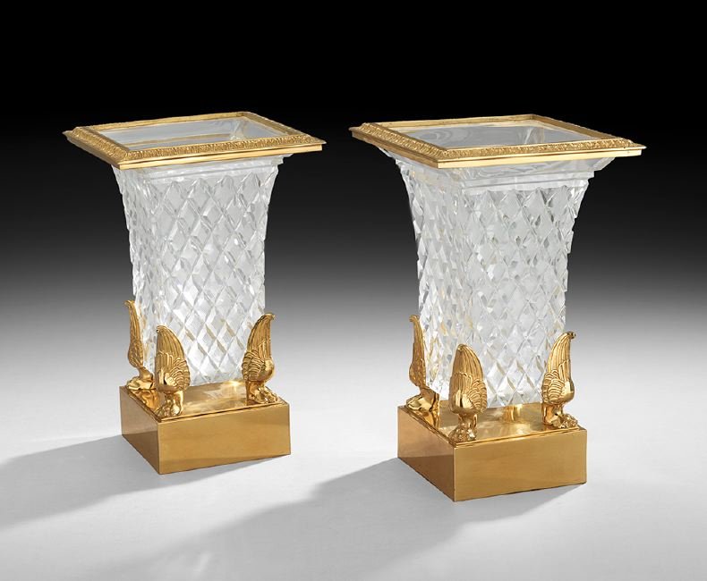 Pair of French Gilt-Bronze and Cut Crystal Vases: Pair of French Empire-Style Gilt-Bronze and Cut Crystal Vases, possibly Baccarat, the flaring vases with square plinths supporting winged paw feet at the corners of the strawberry-cut vases, finished 
