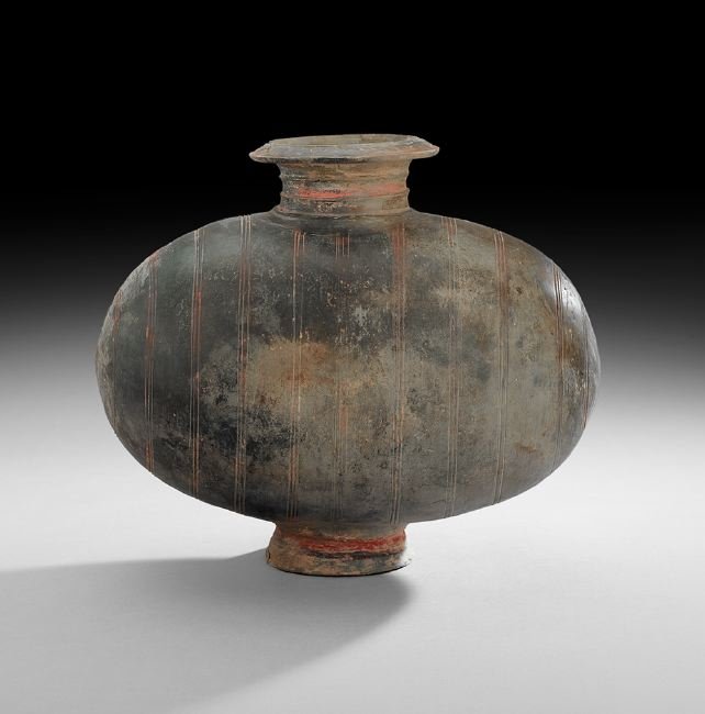Chinese Pottery "Cocoon" Vase: Chinese Pottery "Cocoon" Vase, Han Dynasty (206 BC-220 AD), the footed ovoid vessel with a striped painted and carved surface, h. 13-3/8", w. 15-1/2".