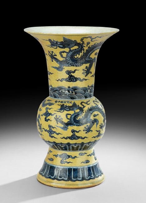 Chinese Porcelain Vase: Chinese Porcelain Vase, late 19th/early 20th century, the zun-form vase with a motif of blue dragons and clouds on a yellow ground, a six-character apocryphal Ming Xuande mark on the body of the vesse