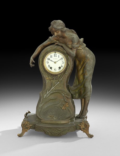 Seth Thomas Art Nouveau Figural Clock: Seth Thomas Art Nouveau Figural Clock, ca. 1900, Thomaston, Connecticut, the patinated metal case flower-molded and decorated with gilt-metal dragonflies, and having a nymph in a flowing gown leaning 
