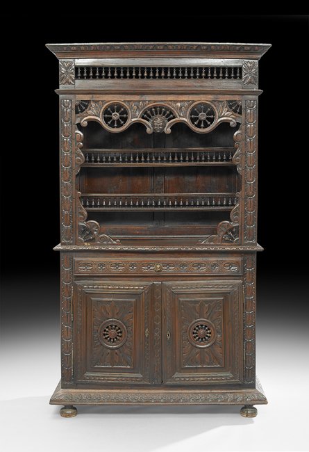 French Provincial Oak Vasselier: French Provincial Oak Vasselier, mid-19th century, probably from Brittany, the foliate-molded cornice above a pierced spindled frieze over a pendant masque and ship's wheels, with two recessed spindle