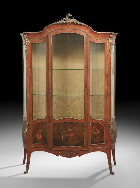 Louis XV-Style Mahogany Vitrine: Louis XV-Style Mahogany Vitrine, early 20th century, the domed cornice with an ormolu foliate crest above a case fitted with a bowed glazed cupboard door, opening to a fabric-lined interior, the lower