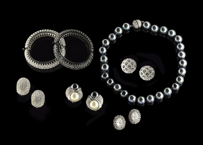 Seven Pieces of Silvertone Fashion Jewelry: Seven Pieces of Silvertone, Crystal and Simulated Tahitian Pearl Fashion Jewelry, late 20th century, including a handsome pair of matching Kenneth J. Lane black and white crystal hinged bangles, insid
