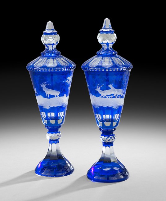 Pair of Bohemian Cobalt-Cased Glass Pokals: Pair of Bohemian Cobalt-Cased, Engraved and Cut Glass Covered Pokals, the bases and covers panel-cut to clear, the sides depicting scenes of deer in a wooded landscape, h. 14-1/4", dia. 4".