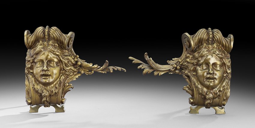 Pair of Bronze Chenets in the Neo-Grec Style: Unusual Pair of English Bronze Chenets in the Neo-Grec Style the design registered in 1886-1887, molded with masques and scrollwork, the back impressed "Rd615143", along with the model numbers, h. 13-