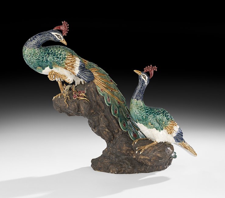 Glazed Pottery Peacock and Peahen: Glazed Pottery Peacock and Peahen 20th century, the pair of birds modeled sitting on rockwork adorned with a prunus sprig, in the Asian style, h. 20-1/4", w. 10", l. 22".