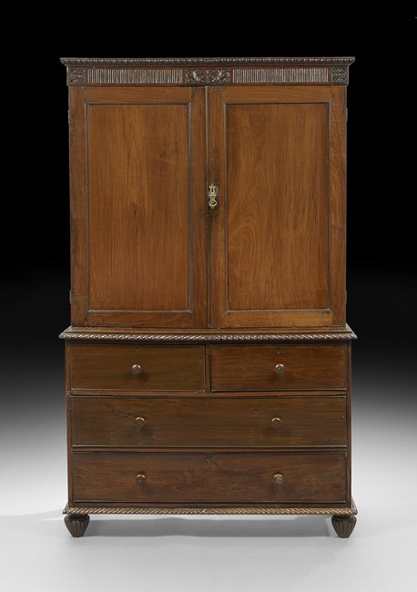 Anglo-Colonial Mahogany Linen Press: Anglo-Colonial Mahogany Linen Press second quarter 19th century, the gadrooned crest above a ribbed frieze centered by a scrolling foliate panel over two paneled doors, opening to three slides over sh