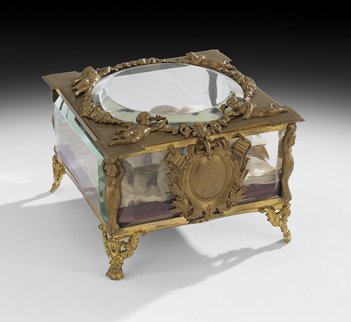 French Gilt-Bronze, Crystal & Fabric Jewel Casket: French Belle Epoque Gilt-Bronze, Crystal and Fabric Jewel Casket ca. 1900, elaborately decorated with putti and wreathes, the beveled glass sides showcasing the tufted fabric interior, raised on pierc