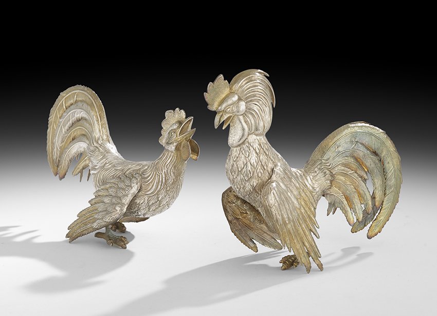 Pair of Silver Fighting Cockerel Table Garnitures: Pair of Spanish Parcel-Gilt Sterling Silver Fighting Cockerel Table Garnitures mid-20th century, by Plateria Espunes, Madrid, the combatant birds realistically detailed with gilt combs, beaks and wing