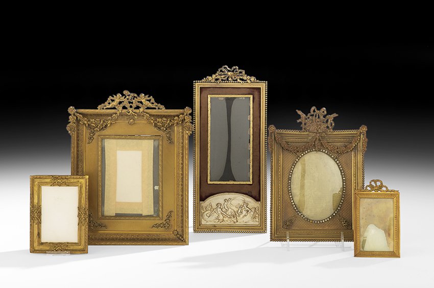 Five French Gilt-Bronze Table Frames: Collection of Five French Gilt-Bronze Table Frames first quarter 20th century, all in the Louis XVI taste, comprising a small frame with crossed ribbons and flowers, h. 5", w. 4-3/4", a larger frame w